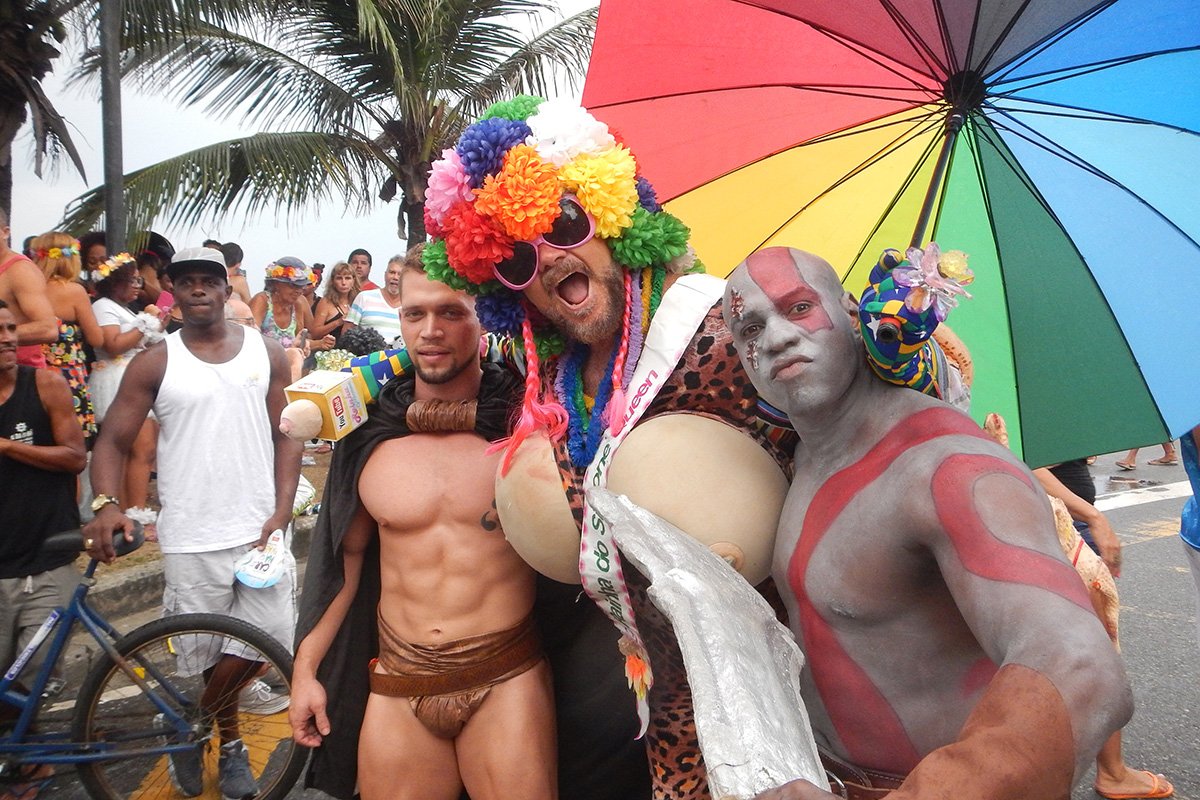 Wild costumes and colorful productions are welcome at street festivities. Rainha do Silicone (in drag) is surrounded by two gladiators.