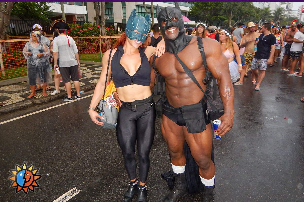 A lovely couple of bodybuilders smiling in their costumes of Batgirl and Batman.